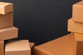 Stack of cardboard boxes against black background Royalty Free Stock Photo