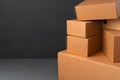 Stack of cardboard boxes against black background Royalty Free Stock Photo