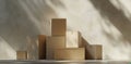 Stack of Cardboard Boxes Against a Cream Wall with Sunlight and Shadows Royalty Free Stock Photo