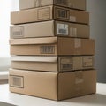 Stack of cardboard boxes arranged on a white table, each featuring barcodes and Royalty Free Stock Photo