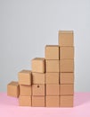 Stack of Cardboard Boxes Forming a Step Pattern on Pink Background Royalty Free Stock Photo