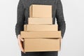 A stack of cardboard boxes in the hands of a people on a white background. Free shipping, return of parcels Royalty Free Stock Photo