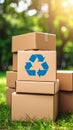 Stack of cardboard boxes with recycling symbol sitting on green grass outdoors in bright sunlight Royalty Free Stock Photo