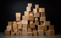 Stack of cardboard boxes in the shape of a pyramid piled up together against a black background Royalty Free Stock Photo