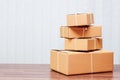Stack of cardboard boxes on wooden table Royalty Free Stock Photo