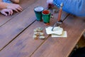 Stack of cards and a handful of coins lie on a wooden table a medieval game