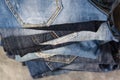 A stack of folded jeans on gray background. Close-up of jeans in different colors. Denim background. Selective focus Royalty Free Stock Photo