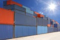 Stack of cargo containers at container yard with sunbeam Royalty Free Stock Photo