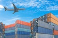 Stack of cargo containers with plane on blue sky background Royalty Free Stock Photo