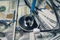 Stack of cash dollars and stethoscope . concept of medical bribe or expensive medicine Royalty Free Stock Photo