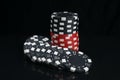 Stack of casino chips in black and red, on a dark background, with reflection Royalty Free Stock Photo