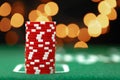 Stack of casino chips on green table against bokeh background Royalty Free Stock Photo
