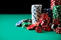 Stack of Casino gambling chips and dices on green table Royalty Free Stock Photo