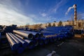 Stack of cast iron pipes in loading area waiting for transportation Royalty Free Stock Photo