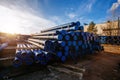 Stack of cast iron pipes in loading area waiting for transportation Royalty Free Stock Photo