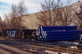 Stack of cast iron pipes in loading area waiting for transportation Royalty Free Stock Photo