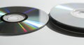 Stack of CDs and a single CD with rainbow reflections Royalty Free Stock Photo