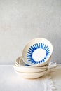 Stack of ceramic bowls with blue pattern on a textured surface, showcasing minimalist design. Royalty Free Stock Photo