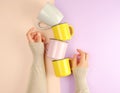 stack ceramic cups are supported by a female hand