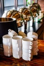 Stack of Ceramics White Cups Set in Neat and Tidy on Vintage Wooden Buffet Table in a Restaurant or Cafe