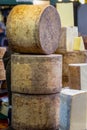 Stack of Cheddar cheese wheels on a market stall Royalty Free Stock Photo