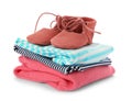 Stack of child clothes and cute shoes isolated