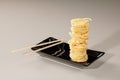 Stack of chinese noodles on black plate and bamboo chopsticks Royalty Free Stock Photo