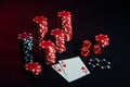 Stack of chips and two cards on dark background - poker game concept Royalty Free Stock Photo