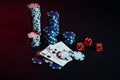 Stack of chips and two cards on dark background - poker game concept Royalty Free Stock Photo