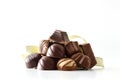 Stack of chocolate bonbons with golden ribbon white isolated background Royalty Free Stock Photo