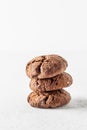 Stack of chocolate brownie cookies with crack on white background. Homemade crinkle cookies