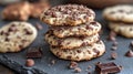 Stack of chocolate chip cookies with chocolate chunks and scattered pieces on dark surface Royalty Free Stock Photo