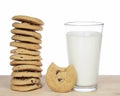 Stack of 12 chocolate chip cookies next to a glass of milk Royalty Free Stock Photo