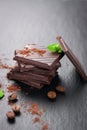 Stack of chocolate chunks with mint on a dark stone background with cocoa Royalty Free Stock Photo