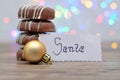 A stack of chocolate covered biscuits and a golden babble with a note for Santa