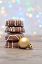 A stack of chocolate covered biscuits and a golden babble