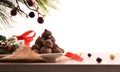 Stack of chocolate truffles with Christmas decoration white isolated background Royalty Free Stock Photo