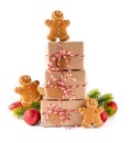 Stack of Christmas gifts boxes in craft paper.with crunchy gingerbread men cookies and bright decoration. Merry Christmas concept Royalty Free Stock Photo