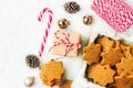 Stack of Christmas shortbread cookies with hazelnuts in star shape golden balls pine cones candy cane gift box on snowy background Royalty Free Stock Photo