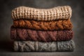 Stack of chunky knitted sweaters folded neatly, featuring rib and cable textures in various colors Royalty Free Stock Photo