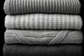 Stack of chunky knitted sweaters folded neatly, featuring various rib and cable knit textures Royalty Free Stock Photo
