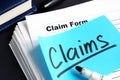 Stack of Claims applications on a desk