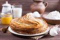 Stack of classic Russian thin pancakes bliny or crepes with honey on a plate. Traditional for the Russian pancake week Maslenit