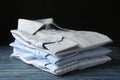 Stack of classic shirts on blue wooden table Royalty Free Stock Photo