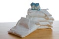 Stack of classical square white cloth diapers with blue socks Royalty Free Stock Photo