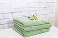 stack clean bath towels colorful cotton terry textile in bathroom white brick background