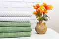 stack clean bath towels colorful cotton terry textile in bathroom white brick background