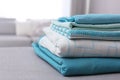 Stack of clean bed linens in room, closeup. Space for text Royalty Free Stock Photo