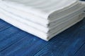 Stack of clean bed sheets on color wooden background, closeup Royalty Free Stock Photo