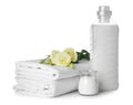 Stack of clean bed sheets and washing detergents on white background